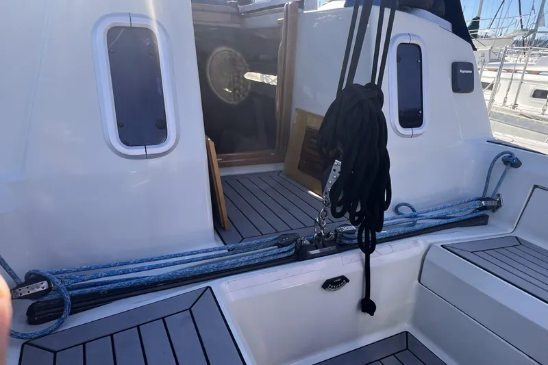 Slide: The Image of 1989 C&C 30 MKII sailboat cockpit with ropes and open cabin door. - 28