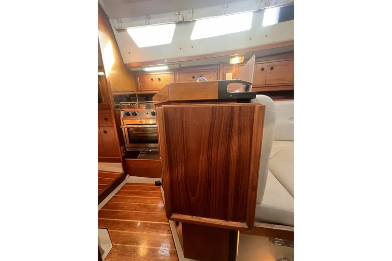 Slide: The Image of Interior of 1989 C&C 30 MKII sailboat with wooden cabinetry and modern stove. - 67