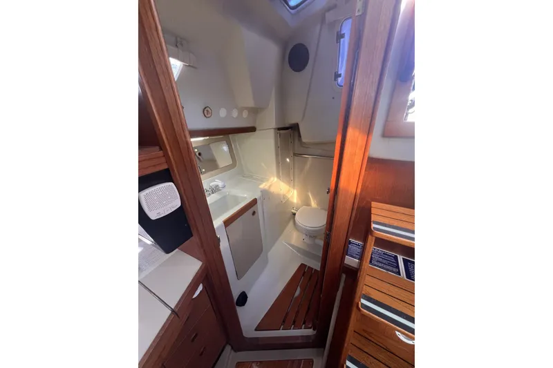 Slide: The Image of Interior of 1989 C&C 30 MKII sailboat, featuring a compact bathroom with wooden accents. - 47