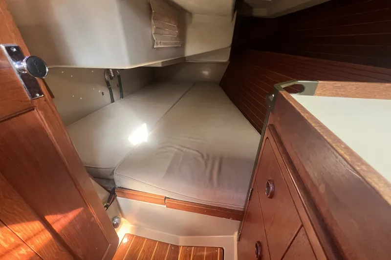 Slide: The Image of Cozy cabin interior of 1989 C&C 30 MKII sailboat with wooden accents and comfortable bedding. - 48