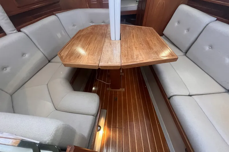 Slide: The Image of Interior of 1989 C&C 30 MKII sailboat with wooden table and cushioned seating. - 78
