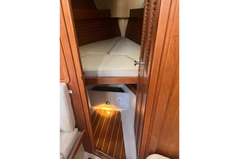 Slide: The Image of Interior cabin of 1989 C&C 30 MKII sailboat with wooden finish and cozy bedding. - 79