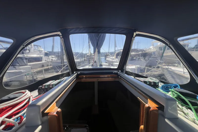 Slide: The Image of Interior view of 1989 C&C 30 MKII sailboat cockpit with marina background. - 43