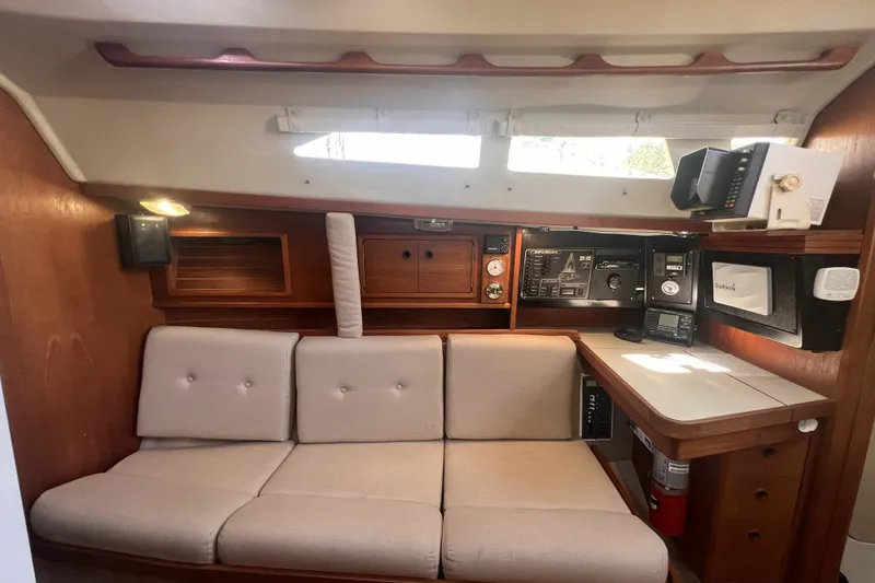 Slide: The Image of Interior of 1989 C&C 30 MKII sailboat with navigation station and cushioned seating. - 75
