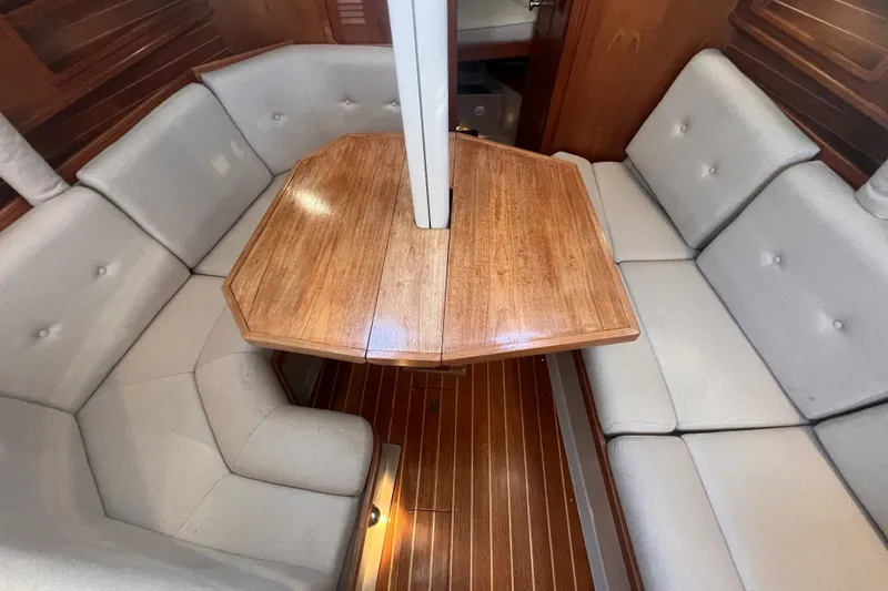 Slide: The Image of Interior of 1989 C&C 30 MKII sailboat with wooden table and cushioned seating. - 77