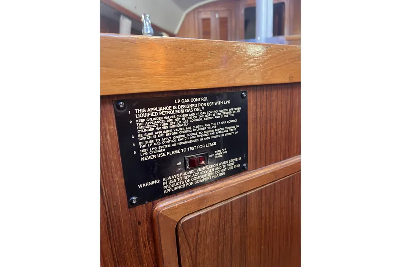 Slide: The Image of LP gas control panel on 1989 C&C 30 MKII yacht interior, featuring safety instructions. - 71