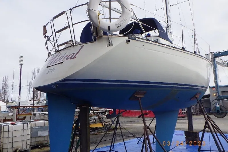 Slide: The Image of 1989 C&C 30 MKII sailboat on stands, with visible hull and lifebuoy. - 92
