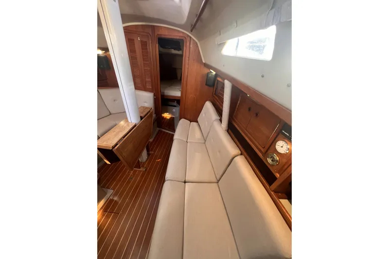 Slide: The Image of Interior of 1989 C&C 30 MKII sailboat with wooden accents and beige seating. - 73