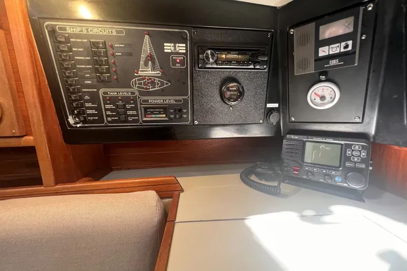 Slide: The Image of Control panel of a 1989 C&C 30 MKII sailboat, featuring ship's circuits and communication equipment. - 53