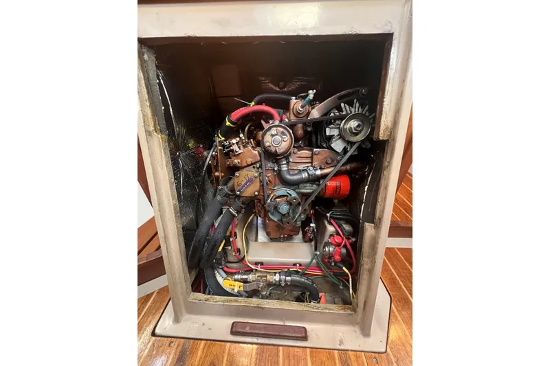 Slide: The Image of Engine compartment of a 1989 C&C 30 MKII sailboat, showcasing detailed mechanical components. - 83