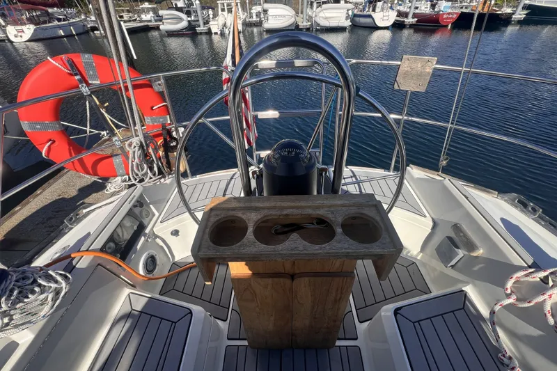 Slide: The Image of Cockpit of 1989 C&C 30 MKII sailboat with steering wheel and marina view. - 25