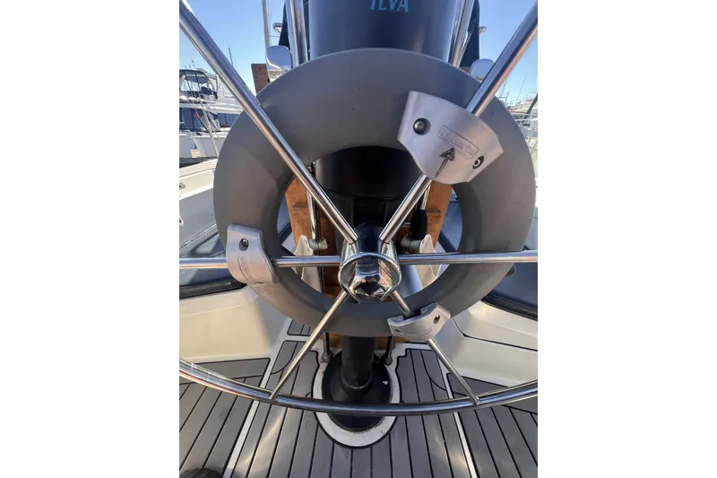 Slide: The Image of Steering wheel of a 1989 C&C 30 MKII sailboat, docked at a marina. - 35