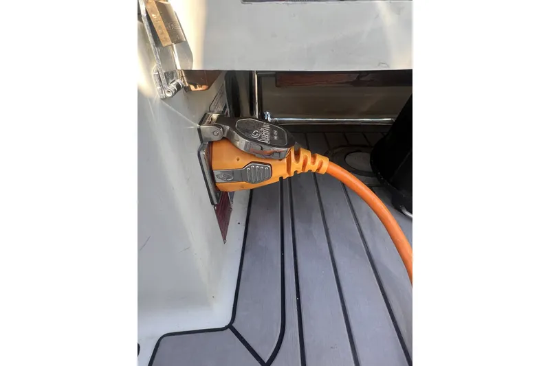 Slide: The Image of Orange power cable connected to a 1989 C&C 30 MKII sailboat. - 38