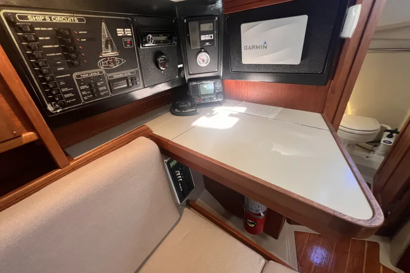 Slide: The Image of Navigation station of 1989 C&C 30 MKII sailboat with control panels and Garmin equipment. - 51