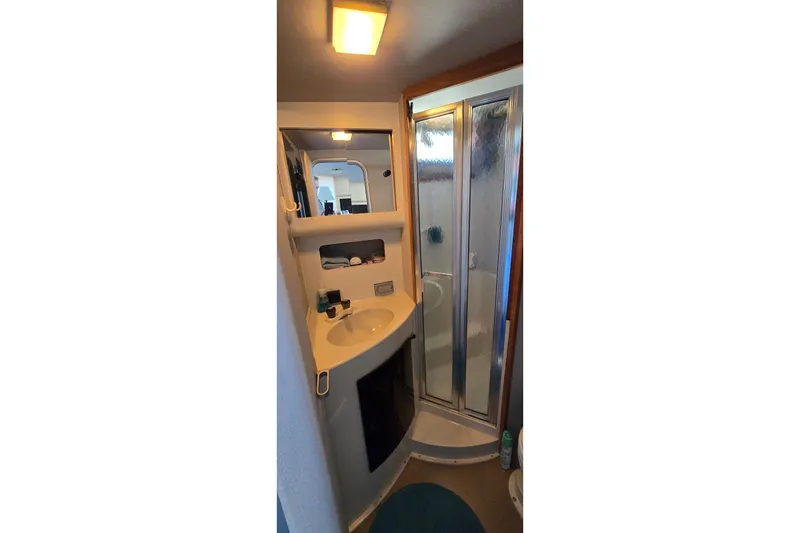 Slide: The Image of Compact bathroom in 1989 Silverton 34 Convertible yacht with shower and sink. - 29