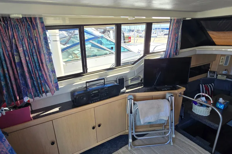 Slide: The Image of Interior of 1989 Silverton 34 Convertible yacht with TV, stereo, and nautical decor. - 20