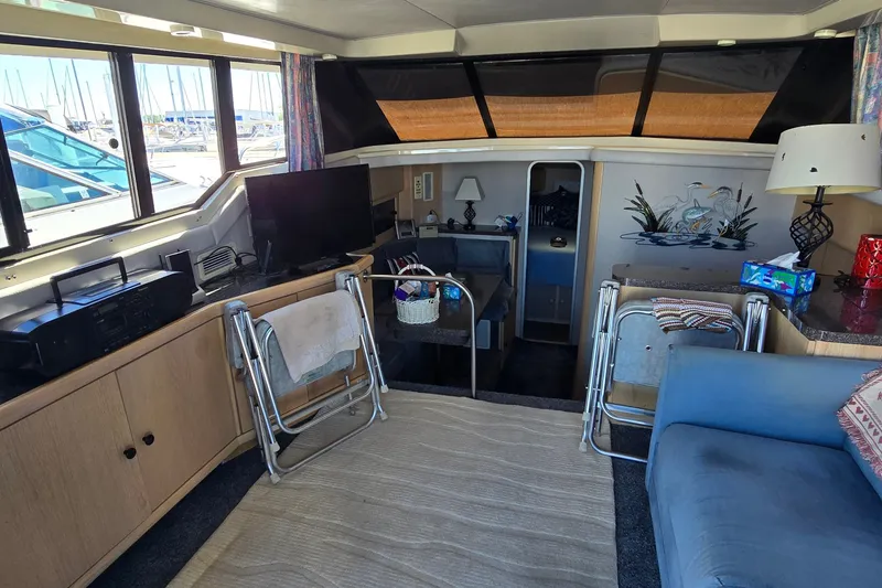 Slide: The Image of Interior of a 1989 Silverton 34 Convertible yacht with cozy seating and decor. - 17