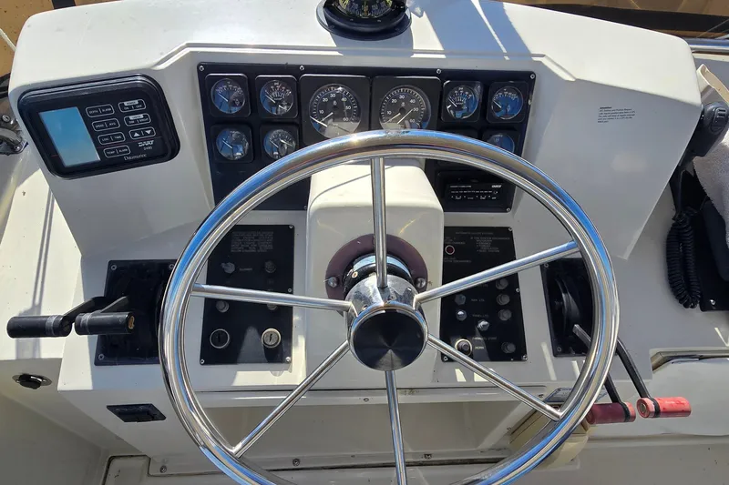 Slide: The Image of 1989 Silverton 34 Convertible helm with steering wheel and control panel. - 15