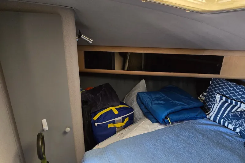 Slide: The Image of Cozy cabin interior of 1989 Silverton 34 Convertible with bedding and storage. - 27