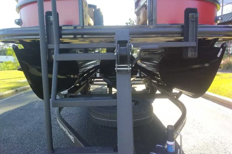 Slide: The Image of 2027 Ranger 223FC boat trailer with dual pontoons on a sunny day. - 16