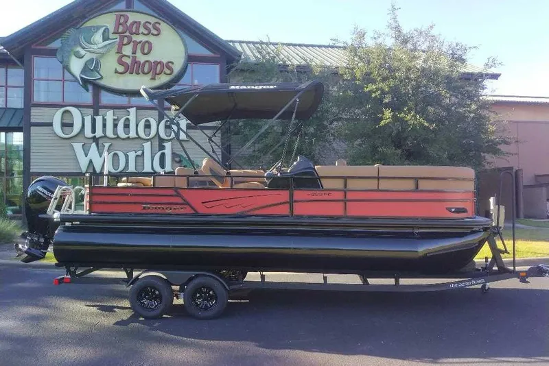 Slide: The Image of 2027 Ranger 223FC pontoon boat displayed outside Bass Pro Shops Outdoor World. - 1