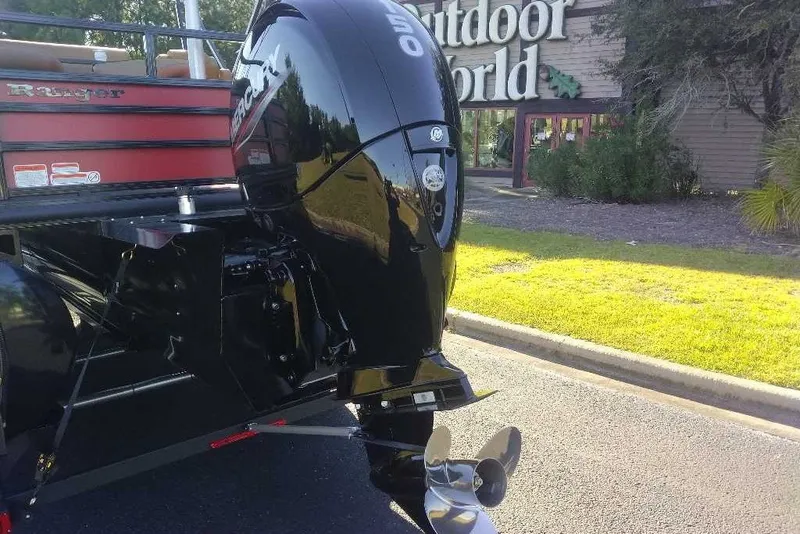 Slide: The Image of Ranger 223FC boat with outboard motor, parked near Outdoor World, 2027 model. - 11