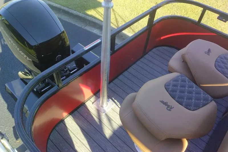 Slide: The Image of Ranger 223FC boat interior with tan seats and Mercury engine, 2027 model. - 6