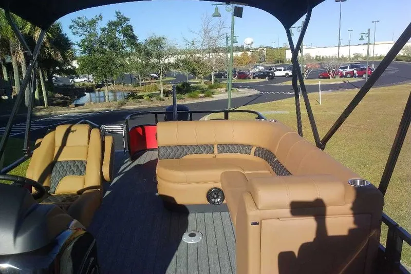 Slide: The Image of 2027 Ranger 223FC boat interior with tan seating and outdoor setting. - 10