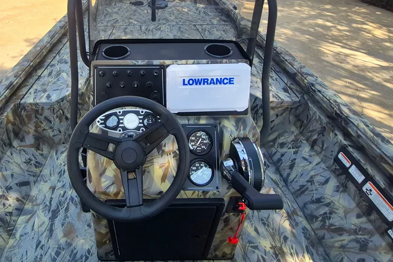 Slide: The Image of 2027 Ranger RB190 boat dashboard with camo design, steering wheel, and Lowrance navigation system. - 11
