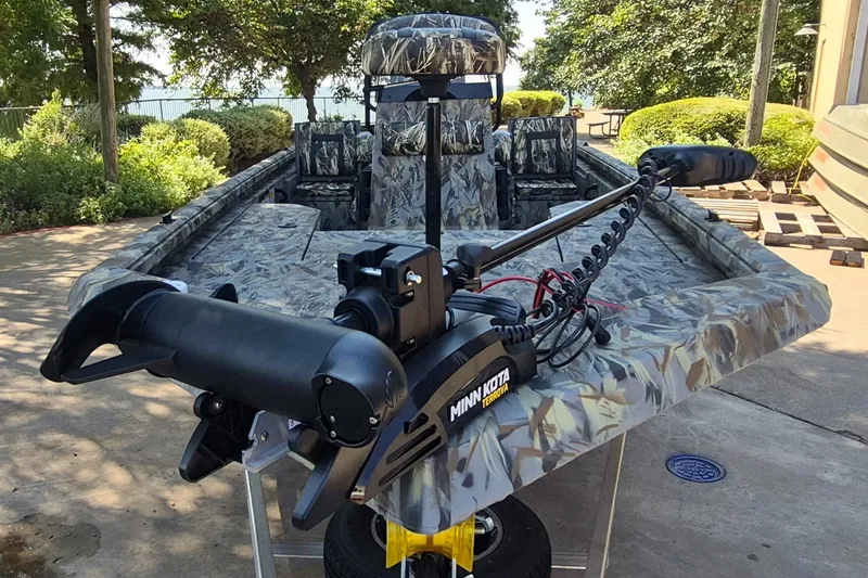 Slide: The Image of 2027 Ranger RB190 boat with Minn Kota Terrova motor, camo design, parked outdoors. - 3