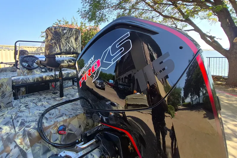 Slide: The Image of 2027 Ranger RB190 boat with Mercury Pro XS 115 engine, camo interior, and scenic background. - 8