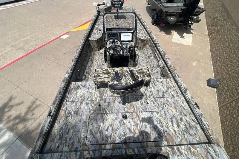 Slide: The Image of 2027 Ranger RB200 boat with camouflage design, featuring a steering console and seating. - 4