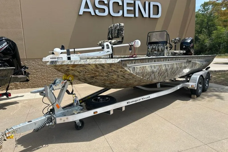 Slide: The Image of 2027 Ranger RB200 boat with camouflage design on a trailer, parked outdoors. - 11