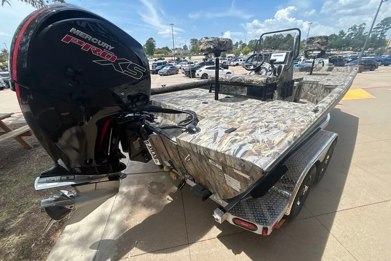 Slide: The Image of 2027 Ranger RB200 boat with Mercury Pro XS engine, camo design, parked outdoors. - 9