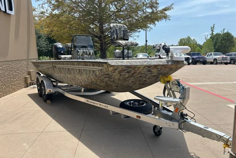 The Image of 2027 Ranger RB200 boat on trailer, camo design, parked outdoors. - 0