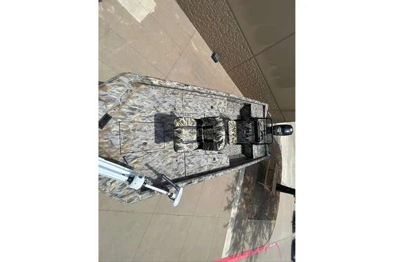 Slide: The Image of 2027 Ranger RB200 boat with camouflage design, viewed from above on pavement. - 1