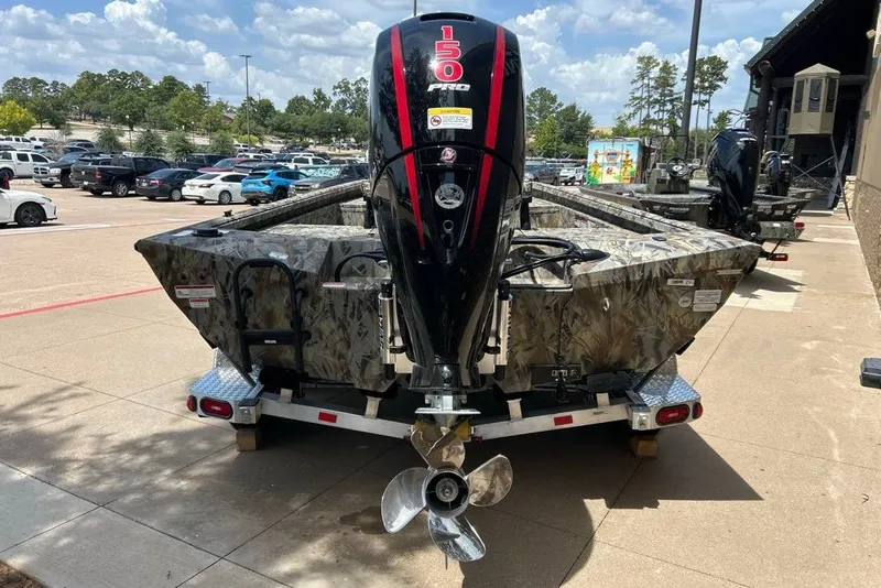 Slide: The Image of 2027 Ranger RB200 boat with camo design and powerful outboard motor in parking lot. - 15