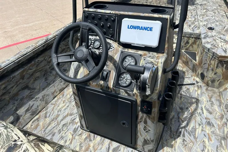 Slide: The Image of 2027 Ranger RB200 boat console with camo design, featuring steering wheel and Lowrance electronics. - 8