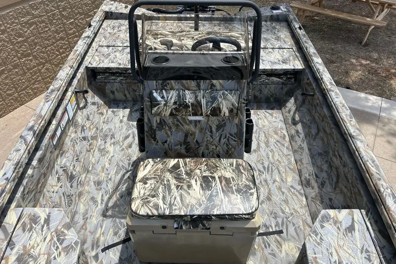 Slide: The Image of Camouflage-patterned interior of a 2027 Ranger RB200 boat, featuring a central steering console. - 2