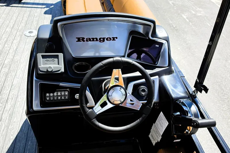 Slide: The Image of Steering console of 2027 Ranger 220FC boat with modern controls and sleek design. - 16
