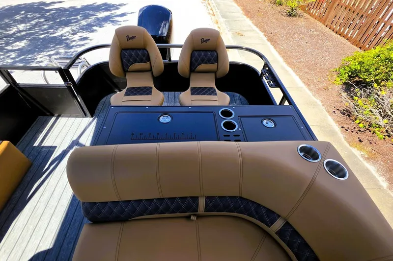Slide: The Image of 2027 Ranger 220FC boat interior with tan seating and cup holders. - 18