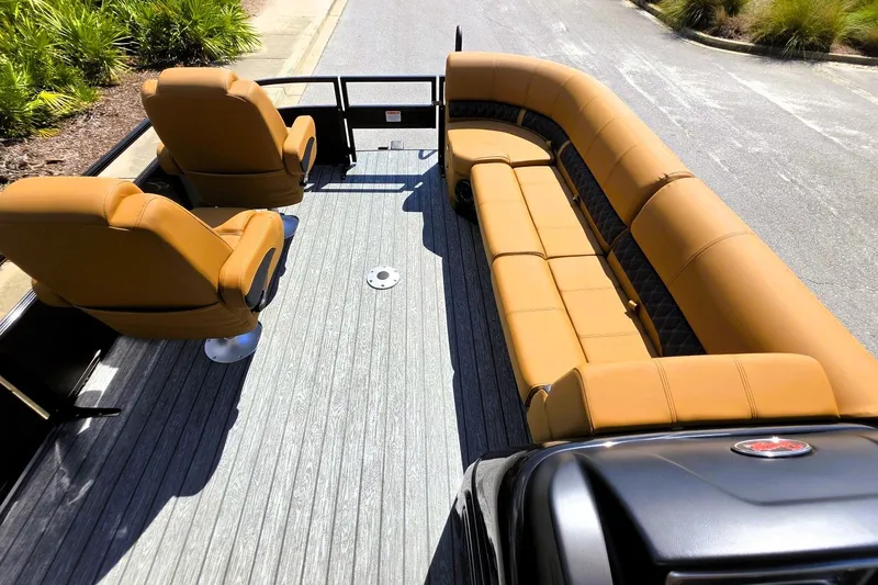 Slide: The Image of Luxurious seating on 2027 Ranger 220FC boat, featuring tan leather and spacious layout. - 21
