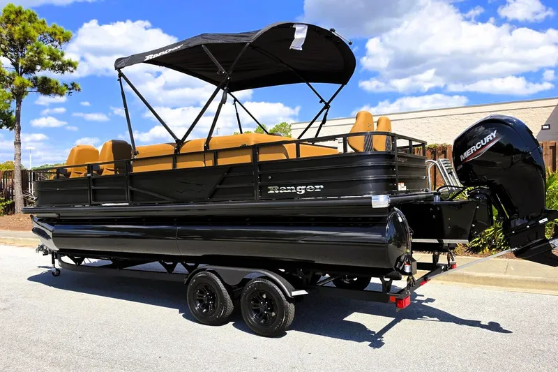 Slide: The Image of 2027 Ranger 220FC pontoon boat with Mercury engine on trailer, under sunny skies. - 13
