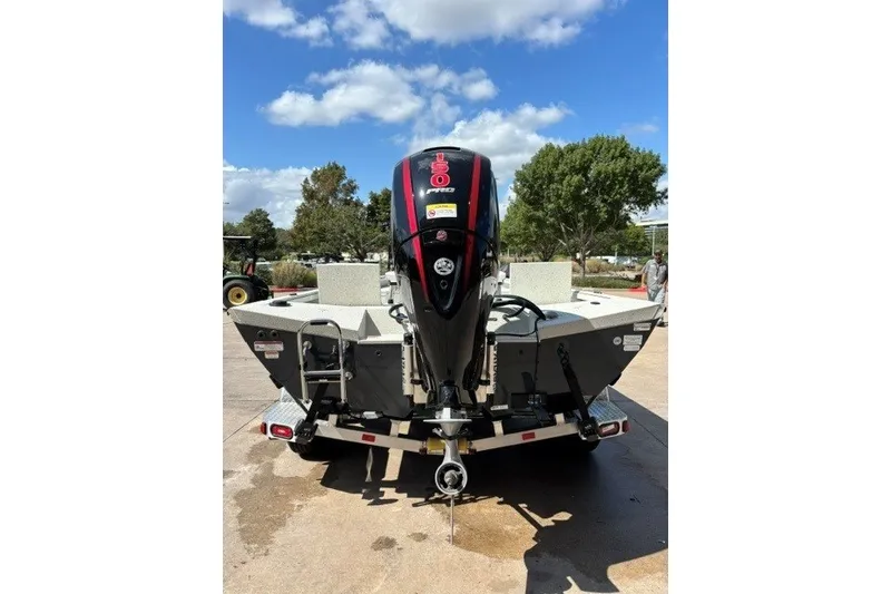 Slide: The Image of 2027 Ranger RB200 boat with powerful outboard motor, parked outdoors under a clear sky. - 14