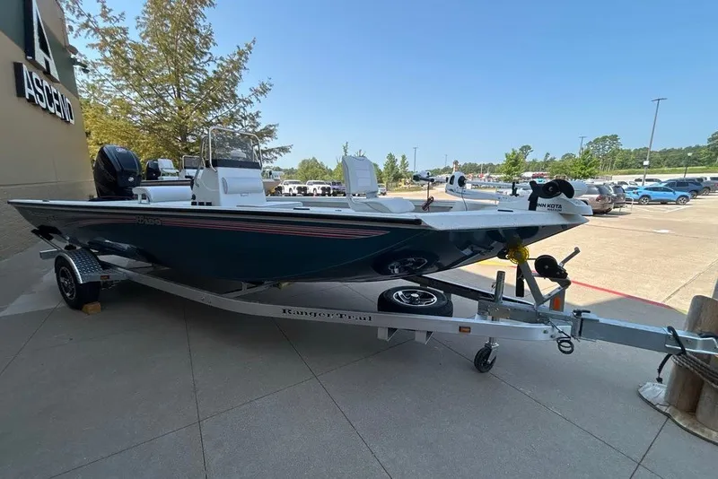 Slide: The Image of 2027 Ranger RB190 boat on trailer, parked outdoors near Ascend building. - 6