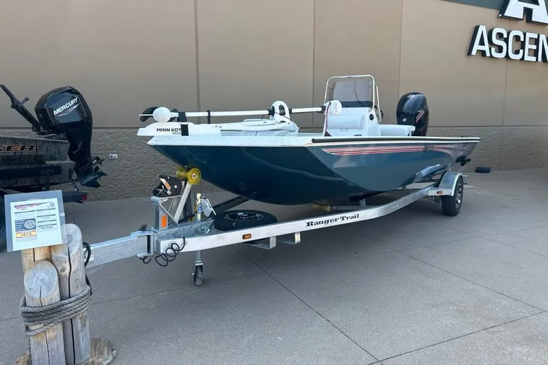 The Image of 2027 Ranger RB190 boat on trailer, displayed outdoors with Mercury engine and Minn Kota trolling motor. - 0