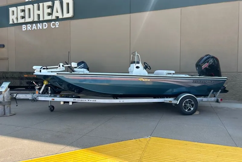 Slide: The Image of 2027 Ranger RB190 boat on trailer outside Redhead Brand Co. store. - 3
