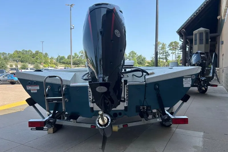 Slide: The Image of 2027 Ranger RB190 boat with outboard motor, parked outdoors on a sunny day. - 1