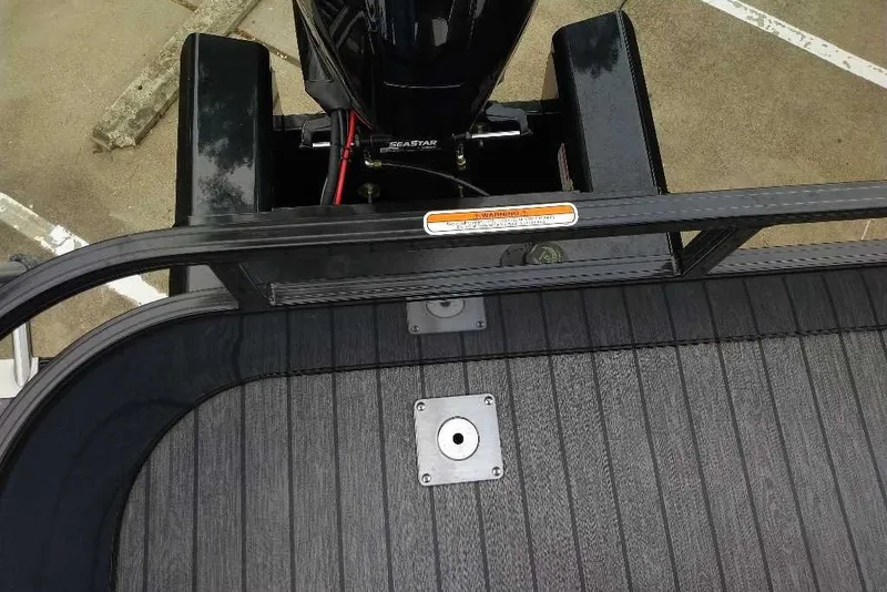 Slide: The Image of Rear deck view of 2027 Ranger 223FC boat with motor and railing. - 2