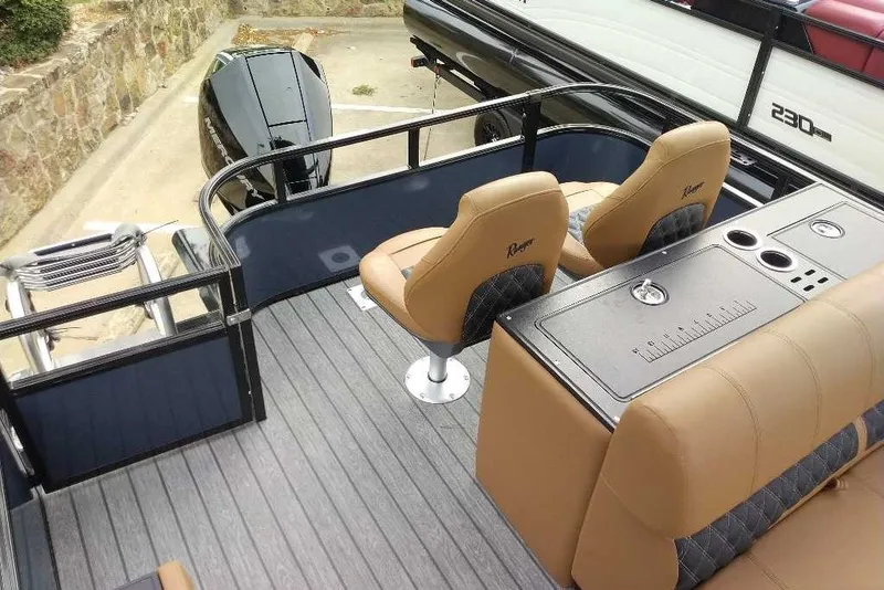 Slide: The Image of 2027 Ranger 223FC boat interior with tan seats and sleek design. - 4